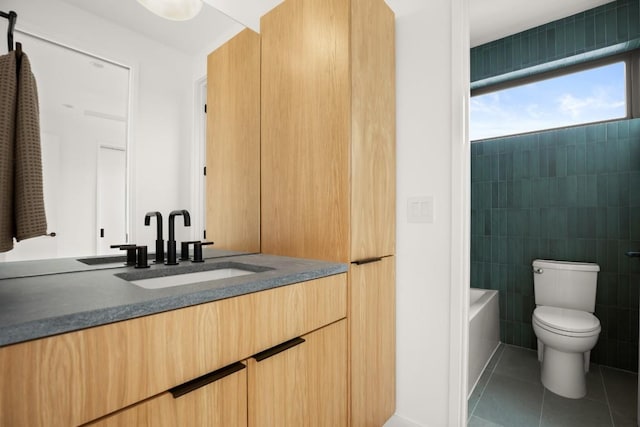 full bath with tile walls, tile patterned floors, toilet, vanity, and a bath