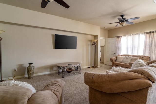 living area featuring carpet floors, a ceiling fan, and baseboards