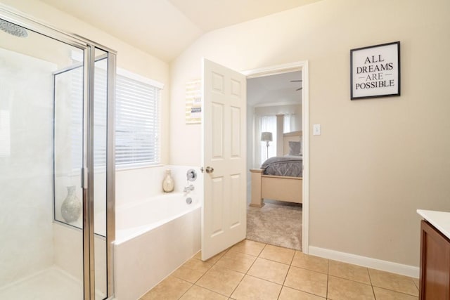 ensuite bathroom with ensuite bath, tile patterned flooring, vanity, a shower stall, and a bath