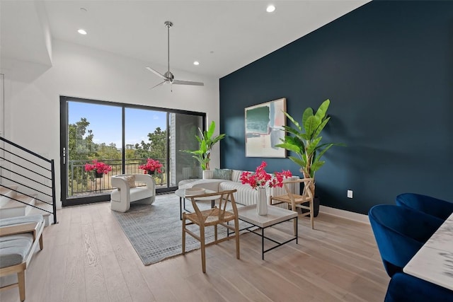 living room with baseboards, ceiling fan, stairway, wood finished floors, and recessed lighting