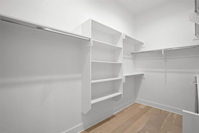 spacious closet with light wood finished floors