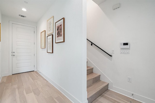 interior space with recessed lighting, wood finished floors, visible vents, and baseboards