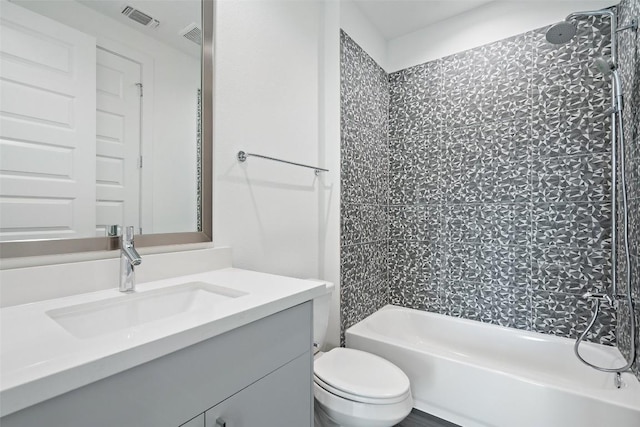 full bathroom featuring visible vents, shower / bathing tub combination, vanity, and toilet