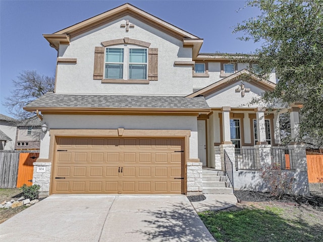 view of front facade with a garage, stone siding, fence, and stucco siding