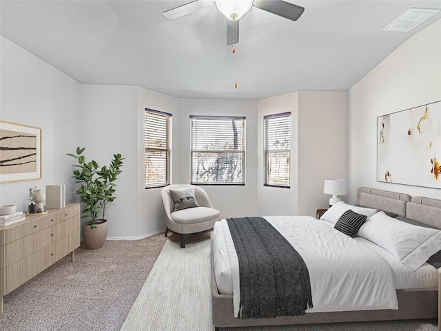 carpeted bedroom with visible vents, ceiling fan, and baseboards