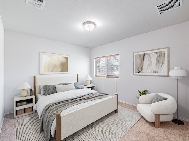 carpeted bedroom with visible vents and baseboards