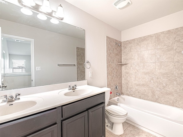 bathroom featuring double vanity, shower / tub combination, a sink, and toilet