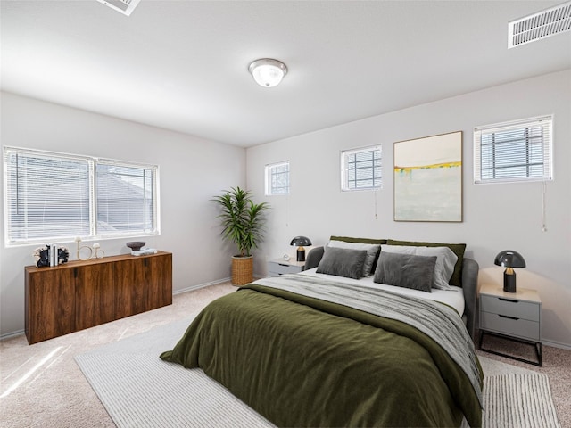 carpeted bedroom with baseboards and visible vents