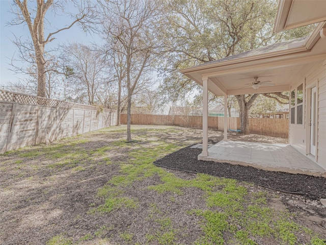 view of yard with a fenced backyard, ceiling fan, and a patio