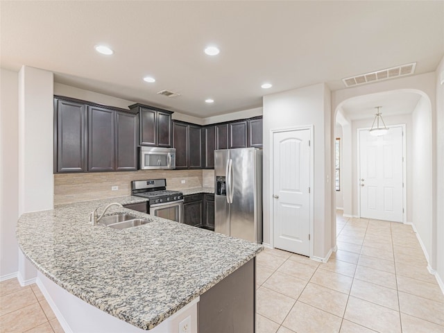 kitchen featuring a peninsula, visible vents, stainless steel appliances, and a sink