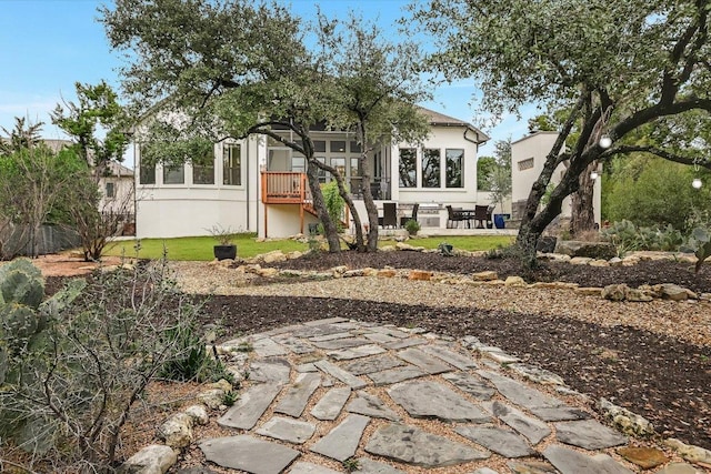 back of house with a patio area and stucco siding