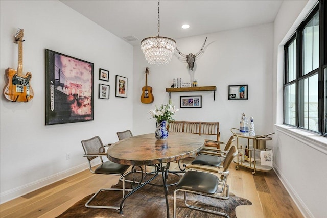 dining area featuring recessed lighting, wood finished floors, visible vents, baseboards, and an inviting chandelier