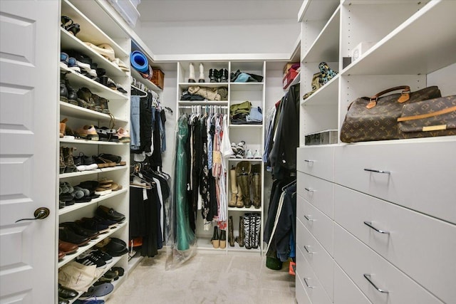 walk in closet featuring carpet flooring