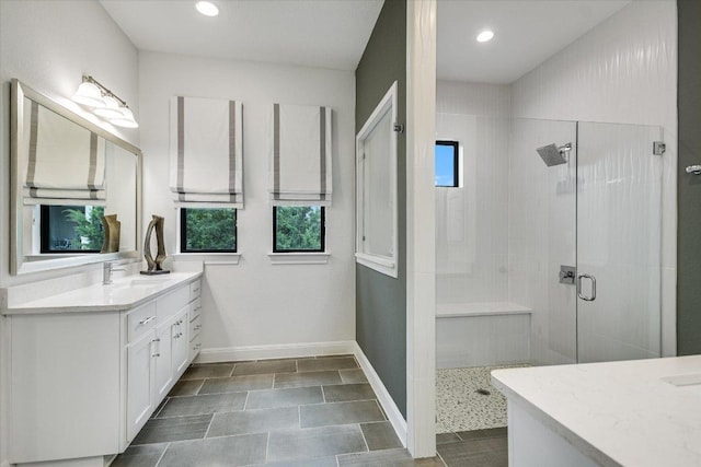 full bath featuring recessed lighting, a shower stall, vanity, and baseboards