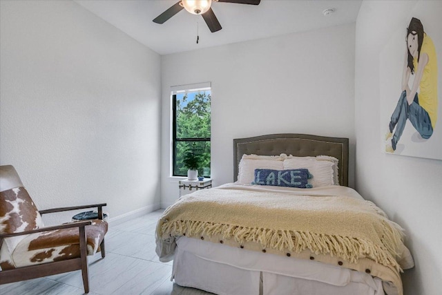 bedroom featuring ceiling fan and baseboards