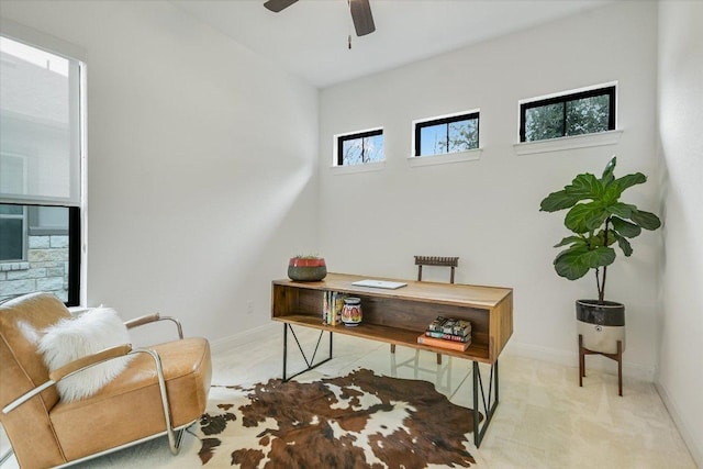 office space with carpet floors, baseboards, and a ceiling fan