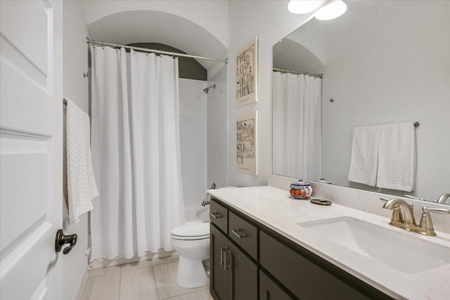 bathroom with toilet, shower / tub combo, and vanity