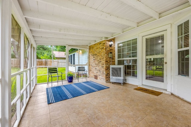 unfurnished sunroom featuring wood ceiling, beam ceiling, and heating unit