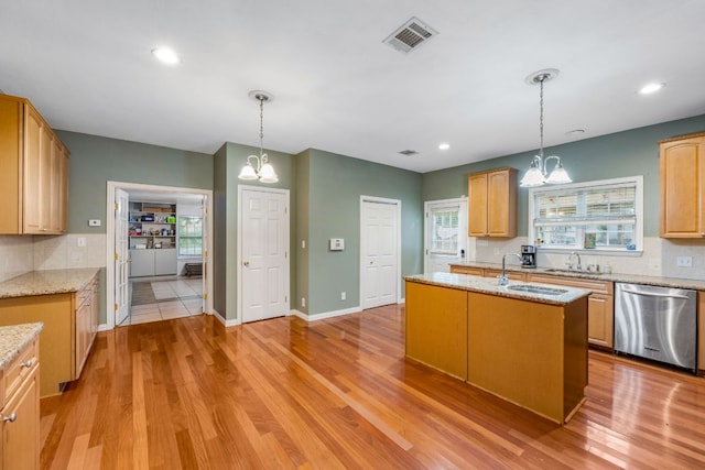 kitchen featuring a chandelier, stainless steel dishwasher, visible vents, and decorative backsplash