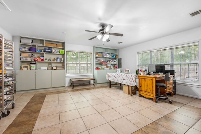 office space with plenty of natural light, visible vents, and tile patterned floors