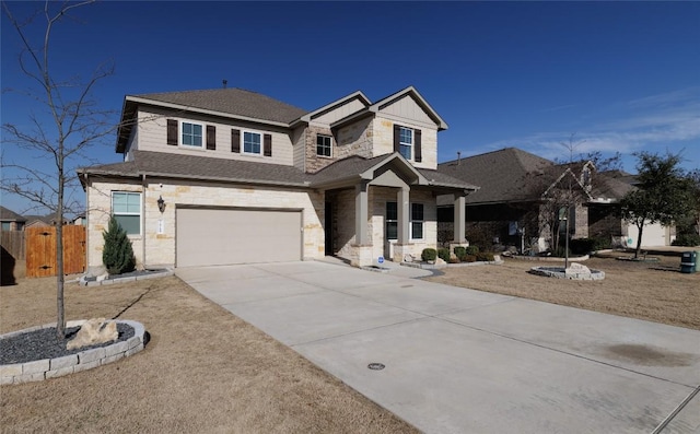 view of front of property featuring concrete driveway, board and batten siding, fence, a garage, and stone siding