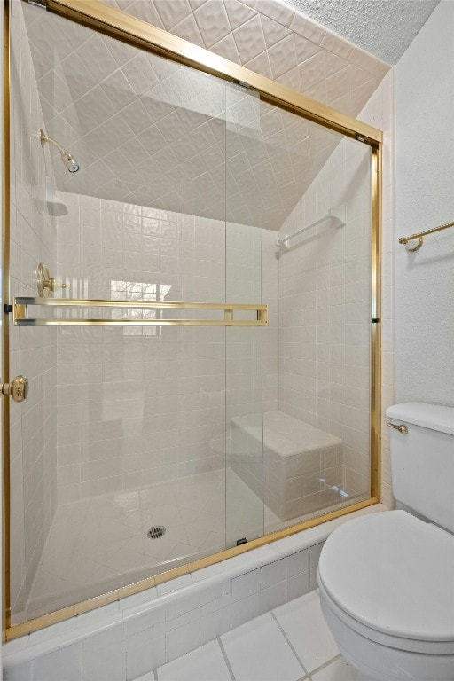 full bathroom with tile patterned flooring, a shower stall, and toilet