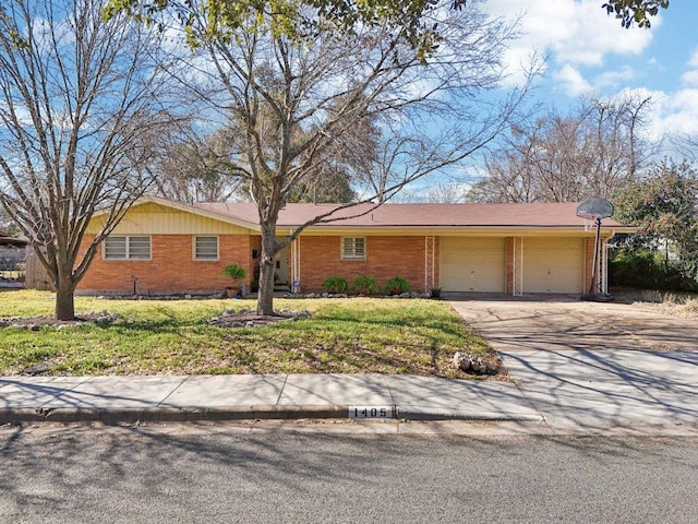 single story home featuring a garage, concrete driveway, brick siding, and a front yard