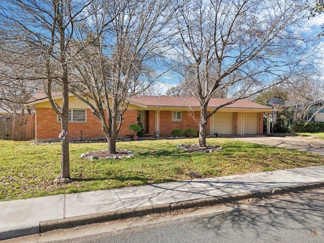 single story home featuring brick siding, concrete driveway, fence, a garage, and a front lawn