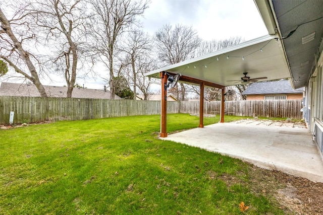 view of yard with a patio area, a fenced backyard, and a ceiling fan