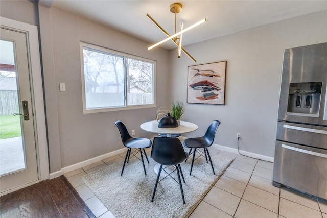 dining area featuring light tile patterned flooring and baseboards