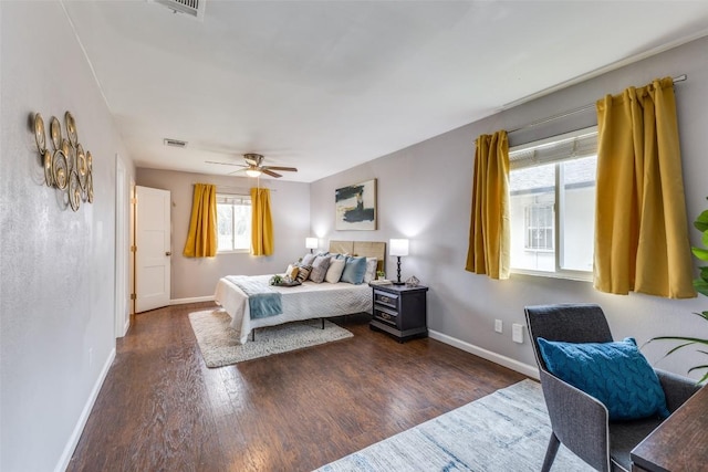 bedroom featuring a ceiling fan, baseboards, visible vents, and wood finished floors