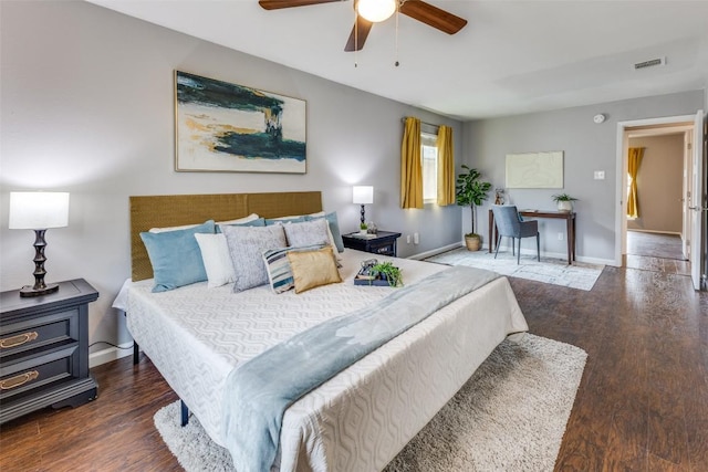 bedroom featuring visible vents, baseboards, and wood finished floors