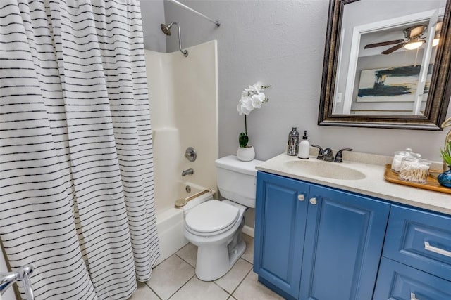 full bath with ceiling fan, tile patterned flooring, toilet, vanity, and shower / bath combo