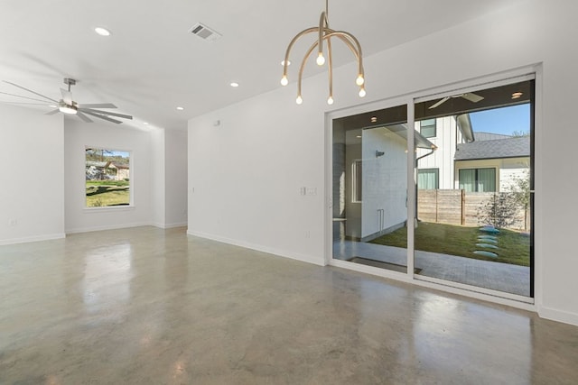 spare room featuring visible vents, finished concrete flooring, baseboards, and ceiling fan with notable chandelier