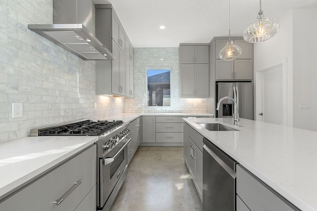 kitchen with tasteful backsplash, gray cabinetry, appliances with stainless steel finishes, a sink, and wall chimney exhaust hood