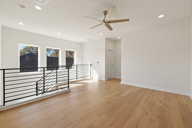 unfurnished room featuring light wood-style floors, baseboards, a ceiling fan, and recessed lighting