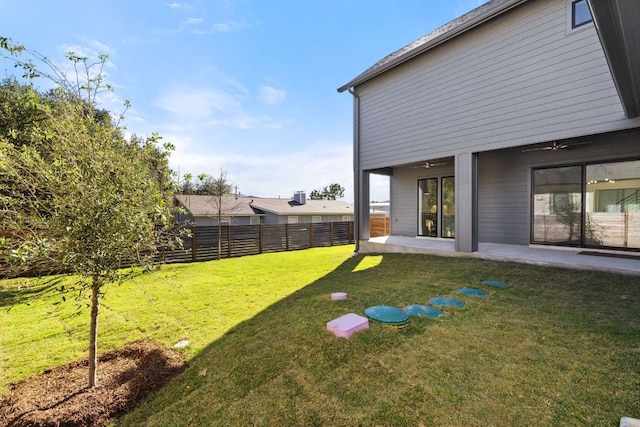 view of yard featuring ceiling fan, a patio, and fence