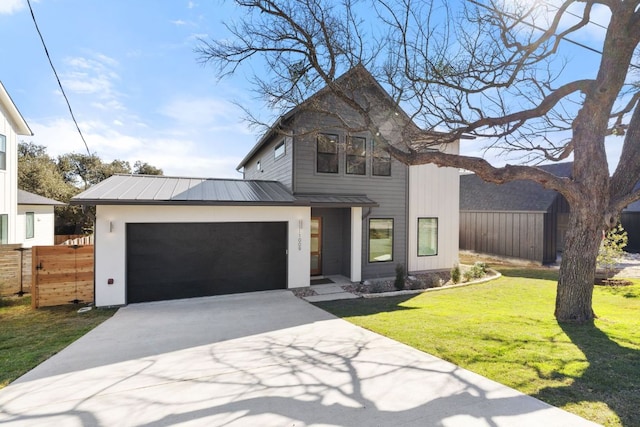 view of front facade featuring a garage, concrete driveway, fence, and metal roof