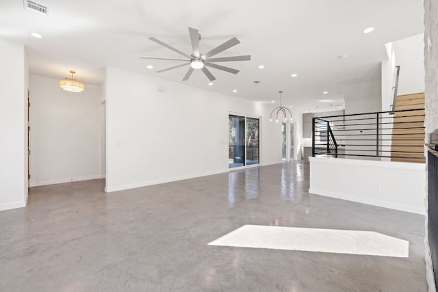 empty room with recessed lighting, visible vents, concrete floors, and stairs