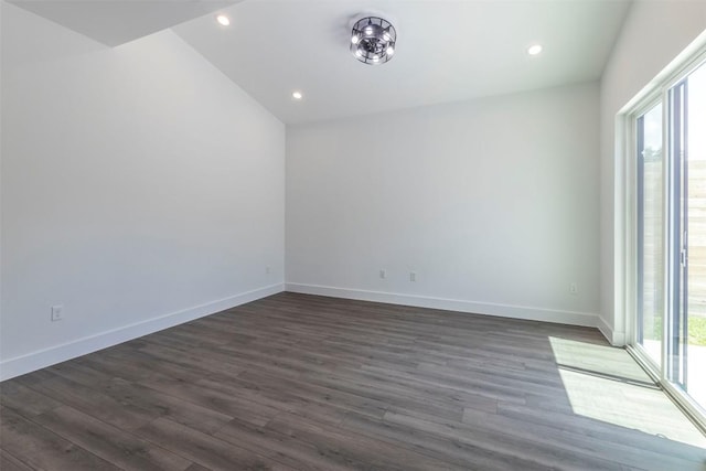 unfurnished room featuring a wealth of natural light, dark wood finished floors, and baseboards