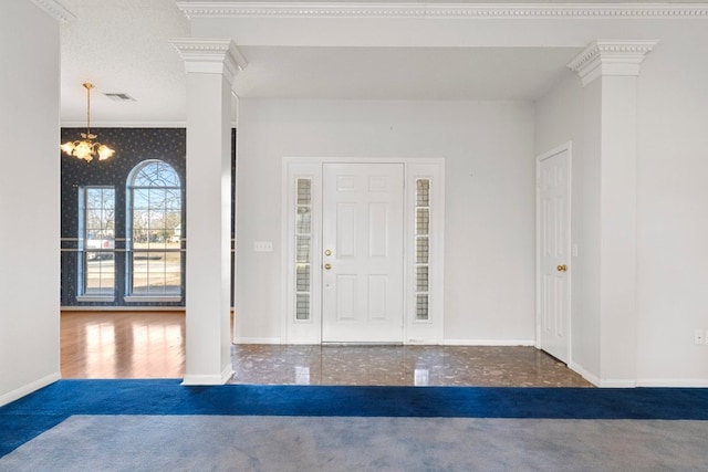 carpeted entrance foyer with crown molding, ornate columns, visible vents, baseboards, and wallpapered walls