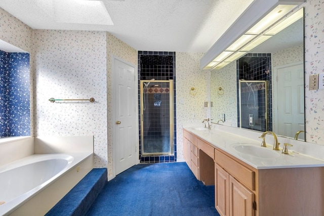 full bath with wallpapered walls, a shower stall, a textured ceiling, and a sink