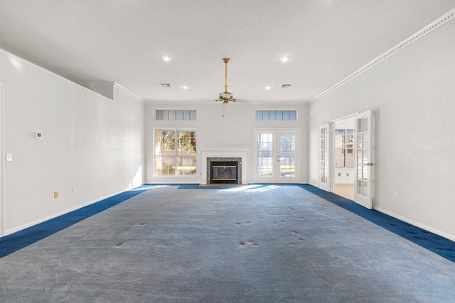 unfurnished living room with baseboards, visible vents, french doors, crown molding, and carpet flooring