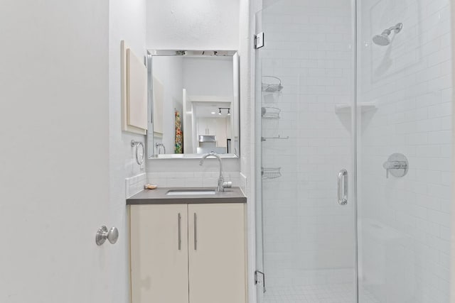 bathroom with a stall shower and vanity