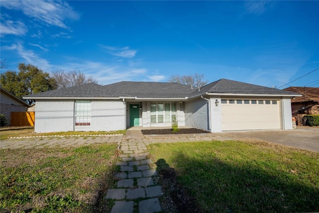 ranch-style house featuring a garage, driveway, brick siding, and a front lawn