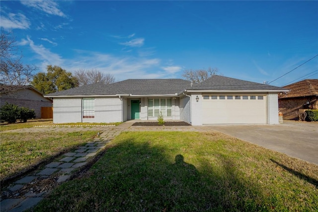 single story home featuring an attached garage, a front lawn, concrete driveway, and brick siding