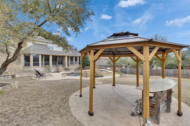 exterior space featuring an outbuilding, a patio, a fenced backyard, a gazebo, and a swimming pool