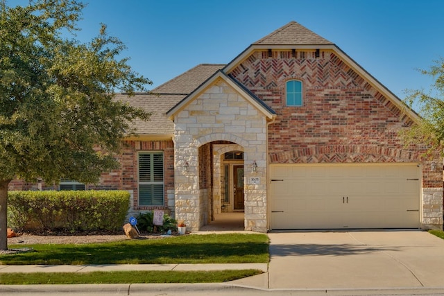 view of front of home with brick siding, stone siding, concrete driveway, and roof with shingles