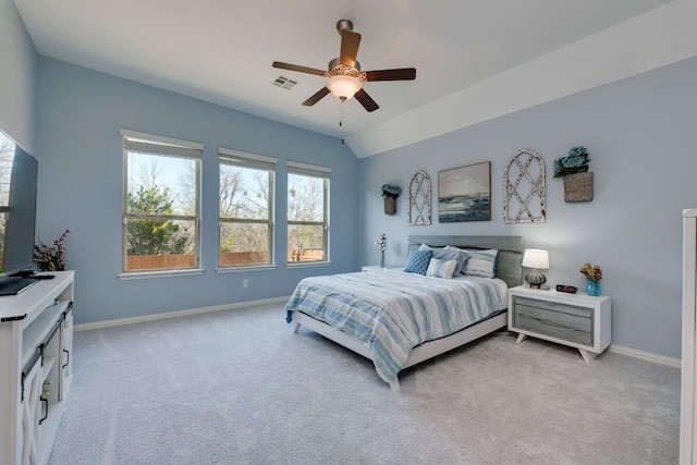 bedroom featuring light carpet, lofted ceiling, visible vents, and baseboards