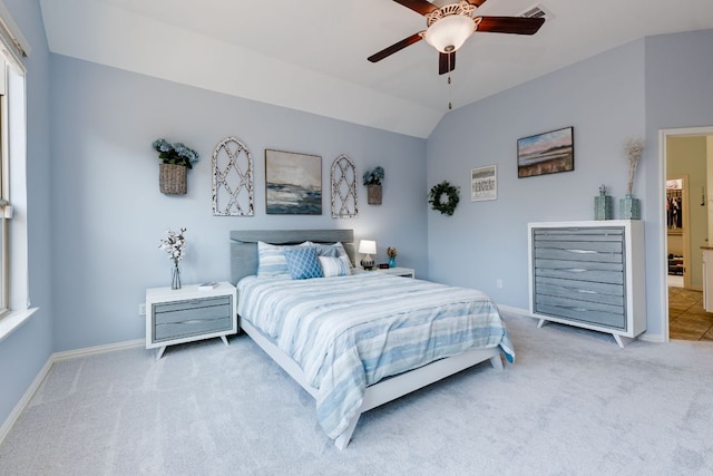 carpeted bedroom featuring vaulted ceiling, ceiling fan, visible vents, and baseboards